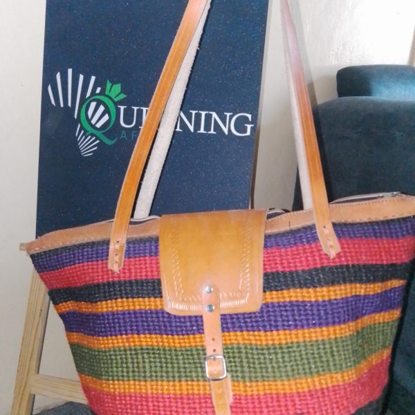 Specifications Material: Sustainable hand-woven fibers and genuine leather. Colorway: Midnight Black with a Royal Violet horizontal accent. Handle Style: Double shoulder straps for comfortable, all-day carry. Origin: Inspired by and crafted through traditional African weaving techniques.