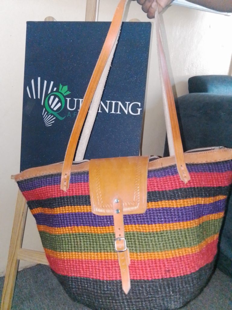 Specifications Material: Sustainable hand-woven fibers and genuine leather. Colorway: Midnight Black with a Royal Violet horizontal accent. Handle Style: Double shoulder straps for comfortable, all-day carry. Origin: Inspired by and crafted through traditional African weaving techniques.