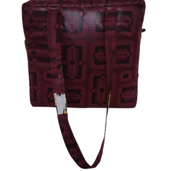 Upgrade your daily carry with our African Print Zip-Top Tote. Perfectly balancing functional design with high-impact aesthetics, this bag takes you from morning meetings to weekend brunch without missing a beat. Product Features: Secure Closure: Durable top zipper to keep your essentials safe. Spacious Design: Roomy interior for your laptop, makeup bag, and daily essentials. Sturdy Straps: Reinforced shoulder straps for comfortable all-day wear. Premium Fabric: 100% authentic African Wax Print (Ankara) with a structured lining.