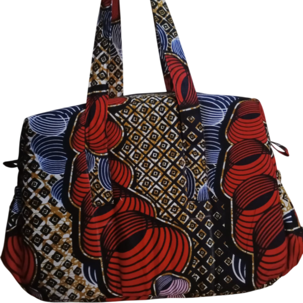 Upgrade your daily carry with our African Print Zip-Top Tote. Perfectly balancing functional design with high-impact aesthetics, this bag takes you from morning meetings to weekend brunch without missing a beat. Product Features: Secure Closure: Durable top zipper to keep your essentials safe. Spacious Design: Roomy interior for your laptop, makeup bag, and daily essentials. Sturdy Straps: Reinforced shoulder straps for comfortable all-day wear. Premium Fabric: 100% authentic African Wax Print (Ankara) with a structured lining.